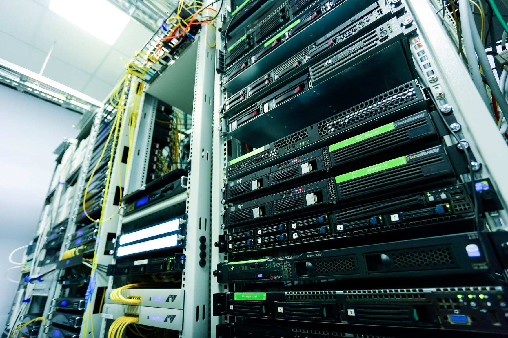 Server room aisle with racks and cabling, network cables and hardware components