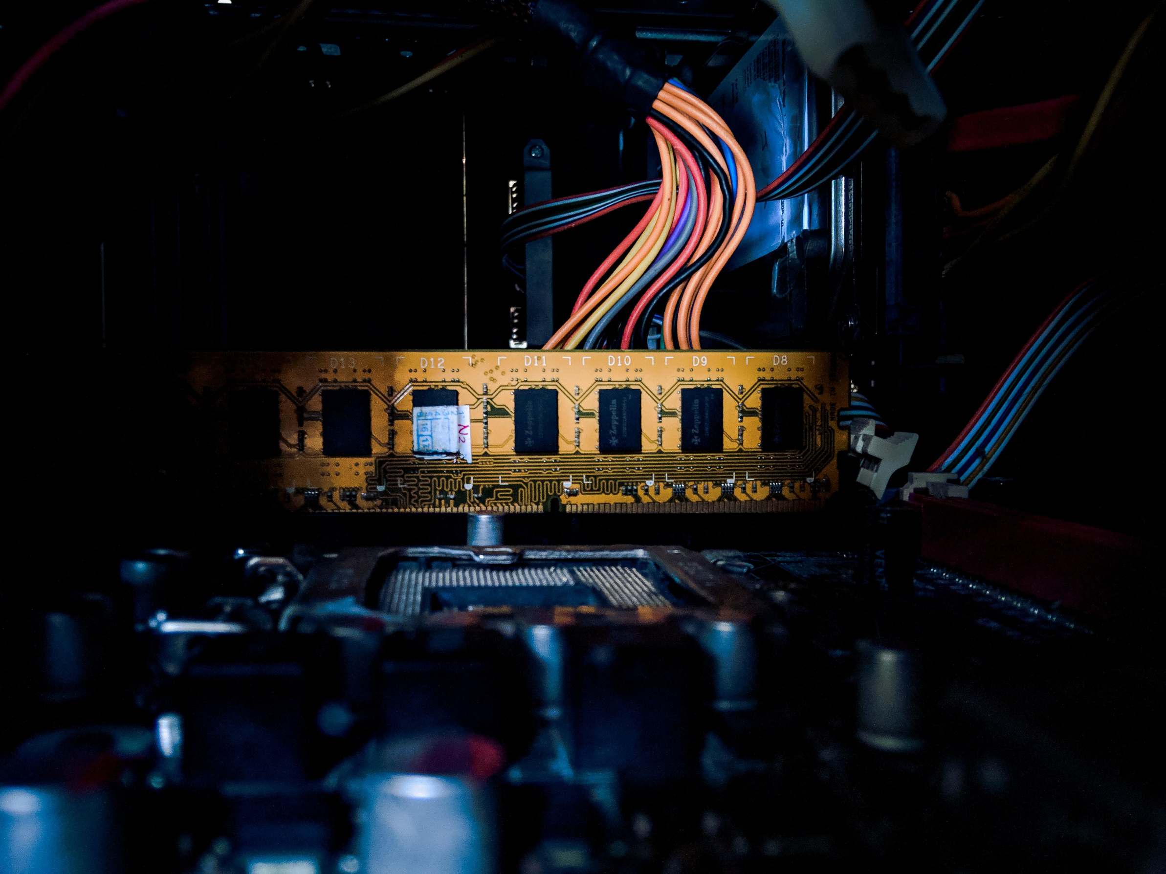 Computer circuit board with cables and electronic components in low light